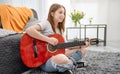 Girl teenager practicing guitar playing