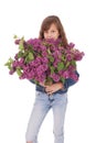 Girl teenager standing with lilac in hands Royalty Free Stock Photo