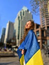 young beautiful girl teenager stands wrapped in flag she closed eyes misses Ukraine people Dream of end of war we are Royalty Free Stock Photo