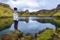 Girl teenager is staying in the border of the pond in the crater Tjarnargigur, one of most impressive craters of Lakagigar