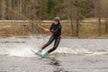 Girl teenager wakeboarders on a lake during a physical education lesson