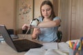 Girl teenager 12-15 years old, plays with a rat, mouse, home laptop lessons. E-education and distance learning through