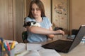 Girl teenager 12-15 years old, plays with rat, mouse, home laptop lessons. E-education distance learning Internet and