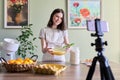 Girl teenager young food blogger cooking orange pancakes