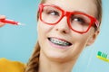 Girl with teeth braces using interdental and traditional brush