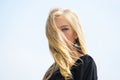 Girl tender blonde makeup face sky background. Bleaching roots. How to repair bleached hair fast and safely. How to take