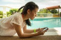 Girl texting at pool side Royalty Free Stock Photo