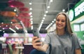 Girl texting on the smart phone in a restaurant terrace with an unfocused background Royalty Free Stock Photo