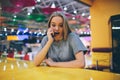 Girl texting on the smart phone in a restaurant terrace with an unfocused background Royalty Free Stock Photo