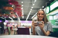 Girl texting on the smart phone in a restaurant terrace with an unfocused background Royalty Free Stock Photo