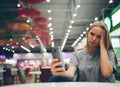 Girl texting on the smart phone in a restaurant terrace with an unfocused background Royalty Free Stock Photo