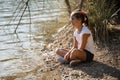 A girl thinking in the lake