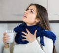 Girl with throat pain gargling throat in kitchen Royalty Free Stock Photo