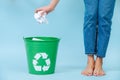 Girl is throwing crumpled paper in recycling bin. Royalty Free Stock Photo