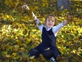 Girl throws up yellow leaves Royalty Free Stock Photo