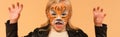 girl with tiger face painting growling Royalty Free Stock Photo