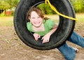 Girl on tire swing Royalty Free Stock Photo