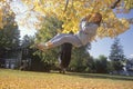 A girl on a tire swing in autumn