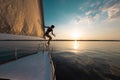 A girl is about to jump into the water from a sailing yacht Royalty Free Stock Photo