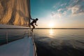 A girl is about to jump into the water from a sailing yacht Royalty Free Stock Photo