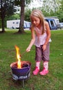 Girl toasting marshmallows on Camp Fire Royalty Free Stock Photo
