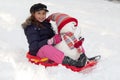 Girl with toboggan and snowman