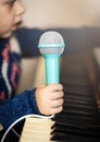 Girl toddler, piano and toy microphone Royalty Free Stock Photo