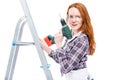 girl with a tool stands on a stepladder Royalty Free Stock Photo