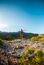 The girl at the top of the mountain raised her hands up. Royalty Free Stock Photo