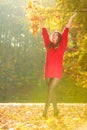 Girl tossing up leaves.