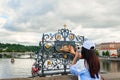 The girl touches the statue of St. John Nepomuk on Charles bridge Prague. The touch of a person to the memorial plaque of the Sain