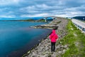 Girl tourist on the background of Storseisundet Bridge Storseisundbrua. Atlantic Ocean Road. Norway Royalty Free Stock Photo