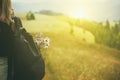 Girl tourist with a backpack and a bouquet of flowers on the background of a mountainous green landscape.e Royalty Free Stock Photo