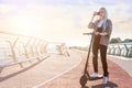 Young woman with colored dreadlocks  riding electric scooter Royalty Free Stock Photo