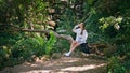 Girl tourist drink water sitting beautiful forest. Woman quenching thirst nature