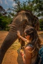 Girl Tourist Feeds bananas to elephant. Thailand Royalty Free Stock Photo