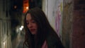 Girl tourist leaning wall town building late evening closeup. Lady at night city Royalty Free Stock Photo