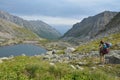 The girl, a tourist looks at a lake in the valley of the Barguzin ridge at Lake Baikal