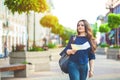 Girl tourist with map in hand on a city street travel guide, tourism in Europe Royalty Free Stock Photo