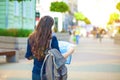 Girl tourist with map in hand on a city street travel guide, tourism in Europe Royalty Free Stock Photo