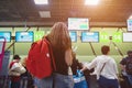 Girl tourist stands in line for check-in and baggage claim at the airport Royalty Free Stock Photo