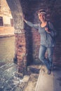 Girl tourist stands at the water`s edge at the door in Venice