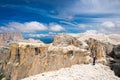 Girl tourist on top in the Alps admires the view. Summer landscape in the Italian Dolomites. South Tyrol Italy. Europe Royalty Free Stock Photo