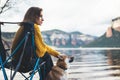 Girl tourist traveler relax think together dog on mountain scape, woman hug pet rest on lake shore nature trip