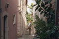 Girl tourist walking through ancient narrow street on a beautiful summer day in Korcula, Croatia Royalty Free Stock Photo