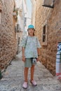 Girl Tourist Walking Through Ancient Narrow Street On A Beautiful Summer Day In Mediterranean Medieval City, Old Town Royalty Free Stock Photo