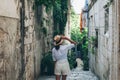 Girl tourist walking through ancient narrow streets on a beautiful summer day in Korcula, Croatia Royalty Free Stock Photo