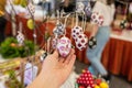Girl tourist walking in the old souvenir market. Woman hand choosing colorful Easter handmade eggs in the Cretan store.