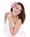 Girl with towel and flower in beautician spa. Royalty Free Stock Photo