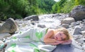 Girl towel in river lying relaxed after swimming Royalty Free Stock Photo